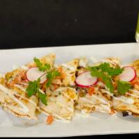 Quesadilla de Carnitas · Flour tortilla, braised pork, Oaxaca and Monterrey cheese, caramelized onions, Mexican sour ...