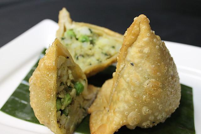 Meat samosa · Triangular pastry stuffed with potatoes and Lamb mince with a hint of spice.