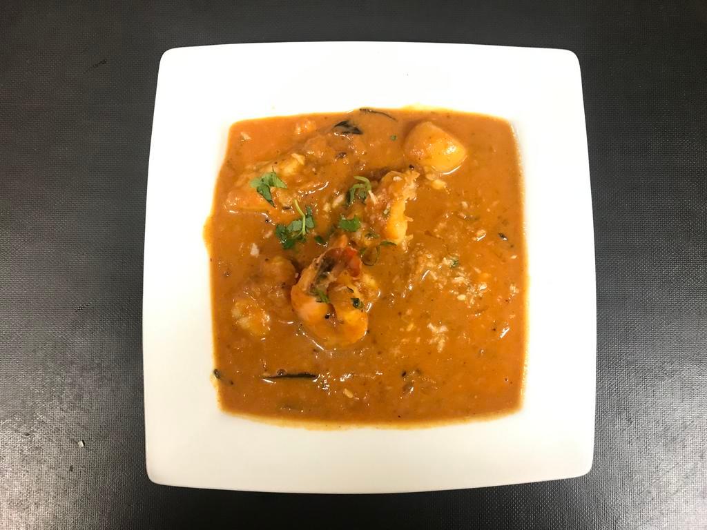 Chicken Tikka Masala · Cubes of chicken breast skewered in tandoor and simmered in tomato and onion with cashew nut gravy.