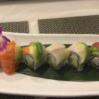 Rainbow Roll · Snow crab meat, avocado, cucumber inside, topped with tuna, salmon, white fish and avocado.