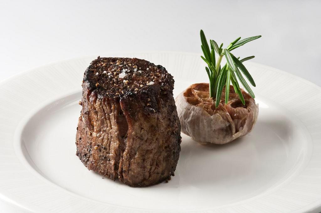 8 oz Center-Cut Filet Mignon · All of our steaks are prepared with our signature Strip House salt and pepper char. Served with roasted garlic and our house made steak sauce . Finished with clarified butter and sea salt.