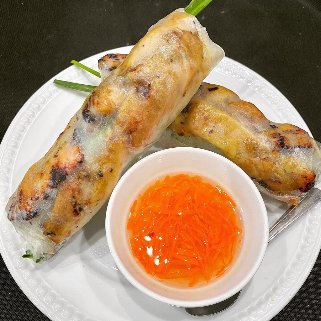 A7. Ga Nuong Cuon · 2 rolls grilled chicken salad rolls. Rice paper wrapped grilled chicken, vermicelli, lettuce, cucumber, Thai basil, mint, carrot & daikon, beansprout, chives. Served with fish sauce.
