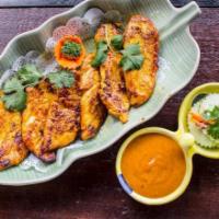 Chicken Satay · Marinated in light curry, served with delicious peanut sauce and cucumber salad.