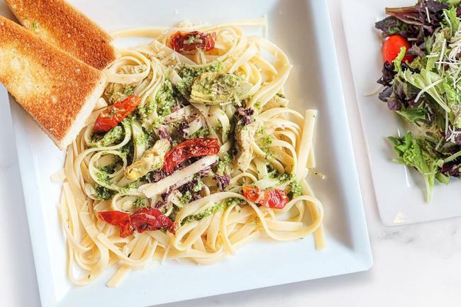 Tuscan Amore · Fettuccine, roasted tomatoes, kalamata olive* tapenade, olive oil, basil pesto, parmesan, garlic & artichokes. Served with your choice of side salad or cup of soup and garlic bread  (Contains Nuts, Vegetarian)