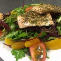 Salmon Salad · Oven roasted salmon fillet atop a bed of mixed greens, tomatoes, fresh orange slices, and dr...