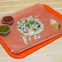 Staple Signature Taco · Smoked brisket, cabbage, pickled onion, Cotija, cilantro, and cilantro cream.