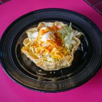 Taco Salad · Your choice of fresh ground beef, tender shredded chicken or picadillo topped with melted ch...