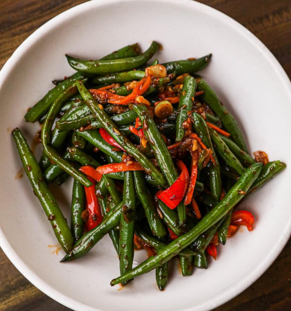 Spicy Vegetarian Sichuan Green Beans · Wok-tossed green beans, carrots, ginger, Fresno peppers.