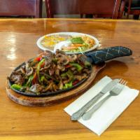 Sizzling Steak Fajitas · Stir-fried tender marinated steak with bell peppers, mushrooms and onions cooked in a unique...