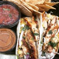 Peanut Chicken Tacos · Georgia peanut sauce, cabbage, pickled red onion, sweet corn and basil salsa.