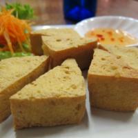 Tofu Triangle · Fried crispy tofu served with sweet sauce topped with ground peanut.