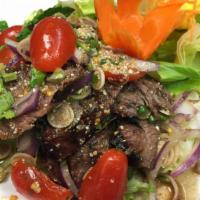 Spicy Beef Salad · Grilled beef mixed in spicy lime juice with red onion, lemongrass, lettuce, tomato, scallion...