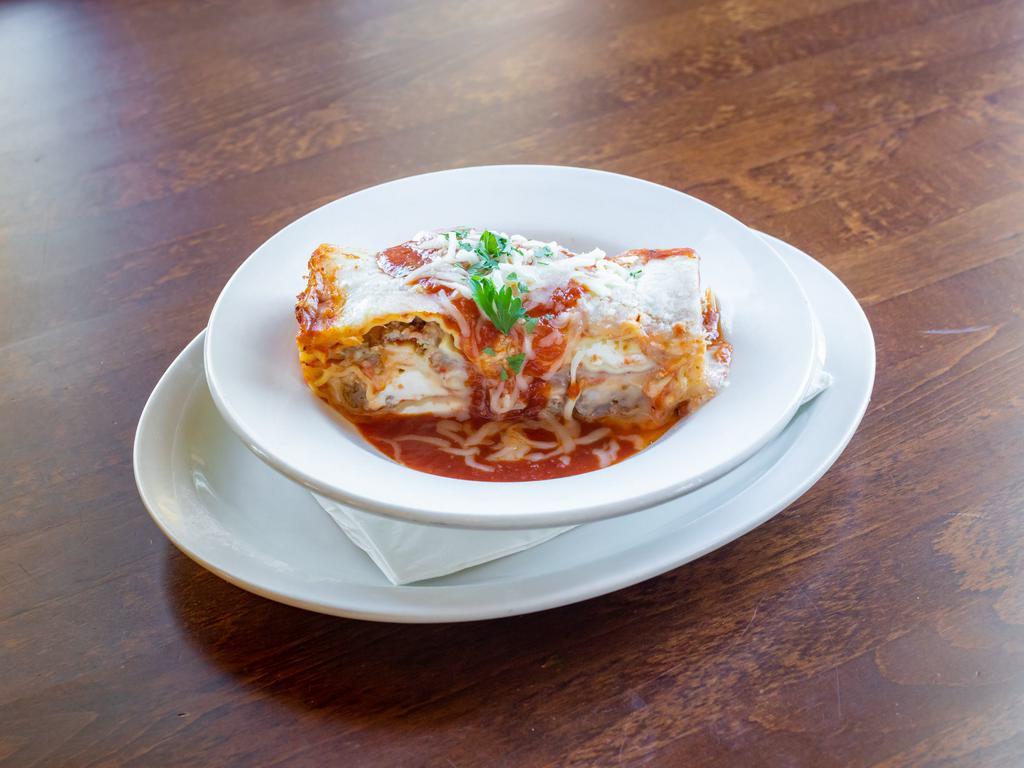 Lasagna · Homemade lasagna made with our homemade sauce. Choice of a cup of soup, tossed salad or coleslaw and garlic toast.