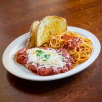 Veal Parmigiana · Breaded veal topped with mozzarella cheese, served with spaghetti and homemade marinara sauc...
