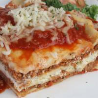 Our Own Baked Stuffed Lasagna · Layers of pasta stuffed with ricotta cheese, fresh mixture of beef, Italian sausage, herbs, ...