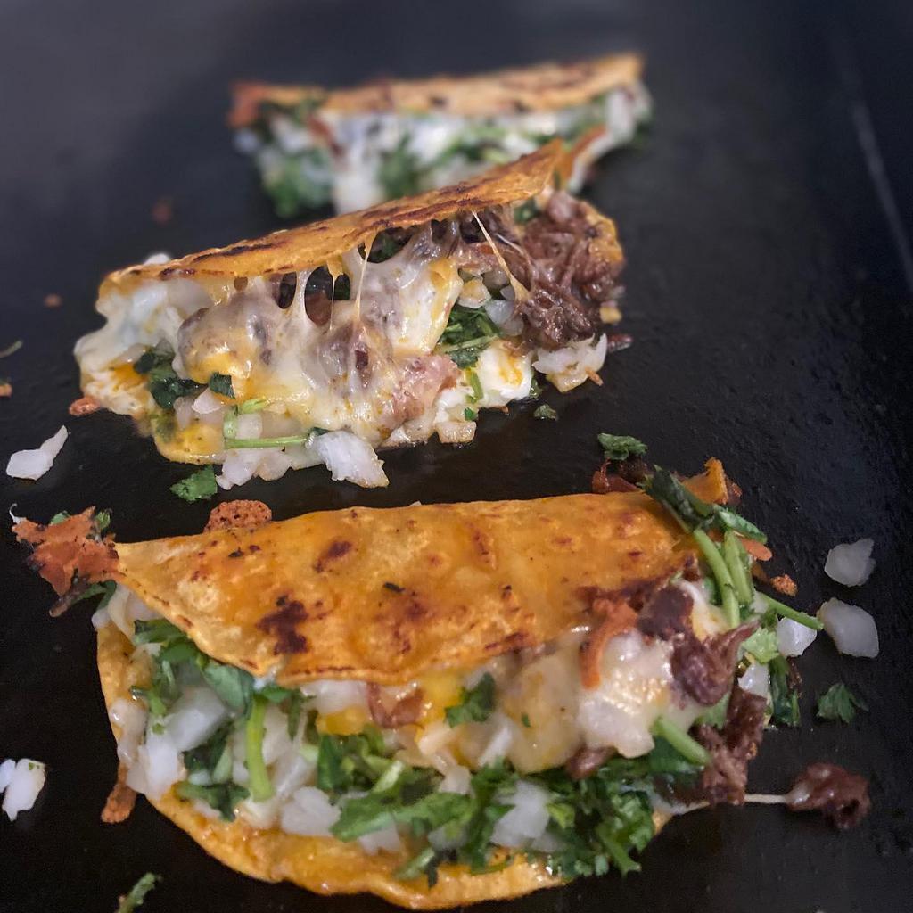 Quesataco · Corn Tortilla Quesataco filled with cheese, protein of choice, onion, cilantro and salsa of choice. Always with a Barbacoa/Birria dipping broth on the side.