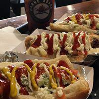 Sonoran Style Hot Dog · Bacon Wrapped Hot Dog on a hot dog bun filled with your favorite toppings