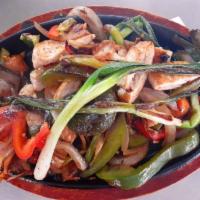 Fajitas · A sizzling plate with your choice of chicken or steak with bell pepper, onions, diced tomato...