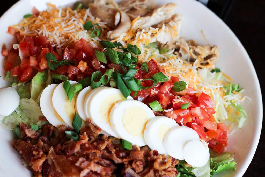 Cobb Salad · Mixed greens, romaine, rotisserie chicken, applewood bacon, tomato, egg, cheddar cheese. Choice of ranch, blue cheese, french, or balsamic dressing served on the side.