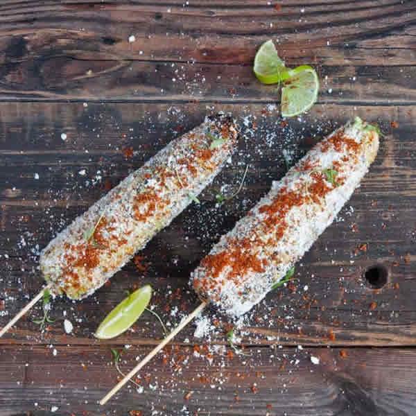 Elote · Street-Style Grilled Corn on the Cob With Tajin Lime, Epazote Aioli & Cotija Cheese