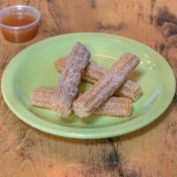 Churros · Served with chocolate and caramel dipping sauce.