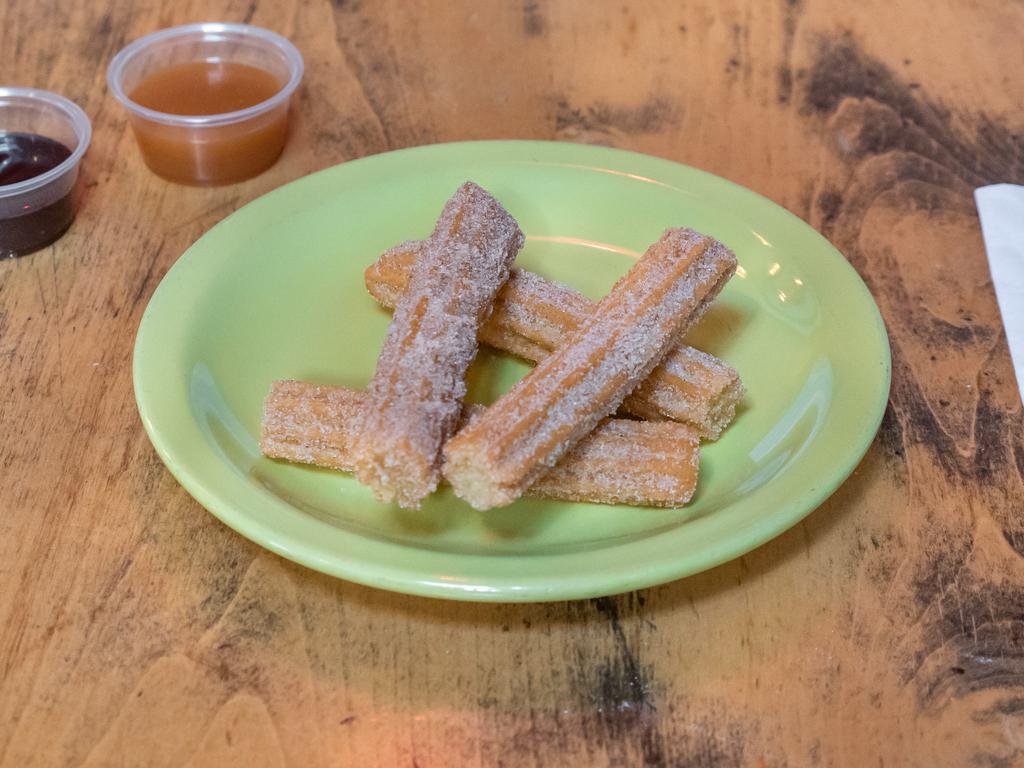 Churros · Served with chocolate and caramel dipping sauce.