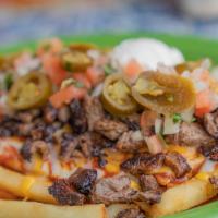 Chili Fries with Carne Asada · Crispy fries topped with chili beans, steak and cheese.