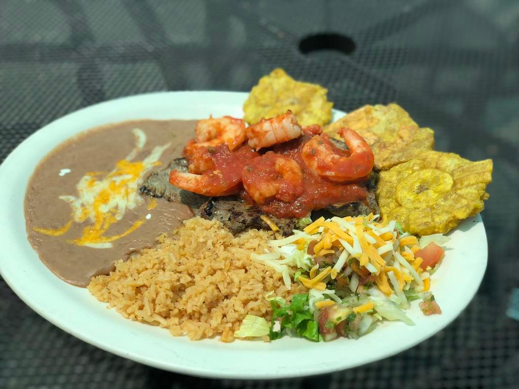 Steak and Shrimp · Steak topped with grilled shrimp in sauce.
NOTE: Plate comes with rice, beans, salad, sour cream and guacamole