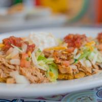 Loaded Tostones · Tostones topped with your choice of shredded meat, pork, beef or chiken and lettuce, cheese,...
