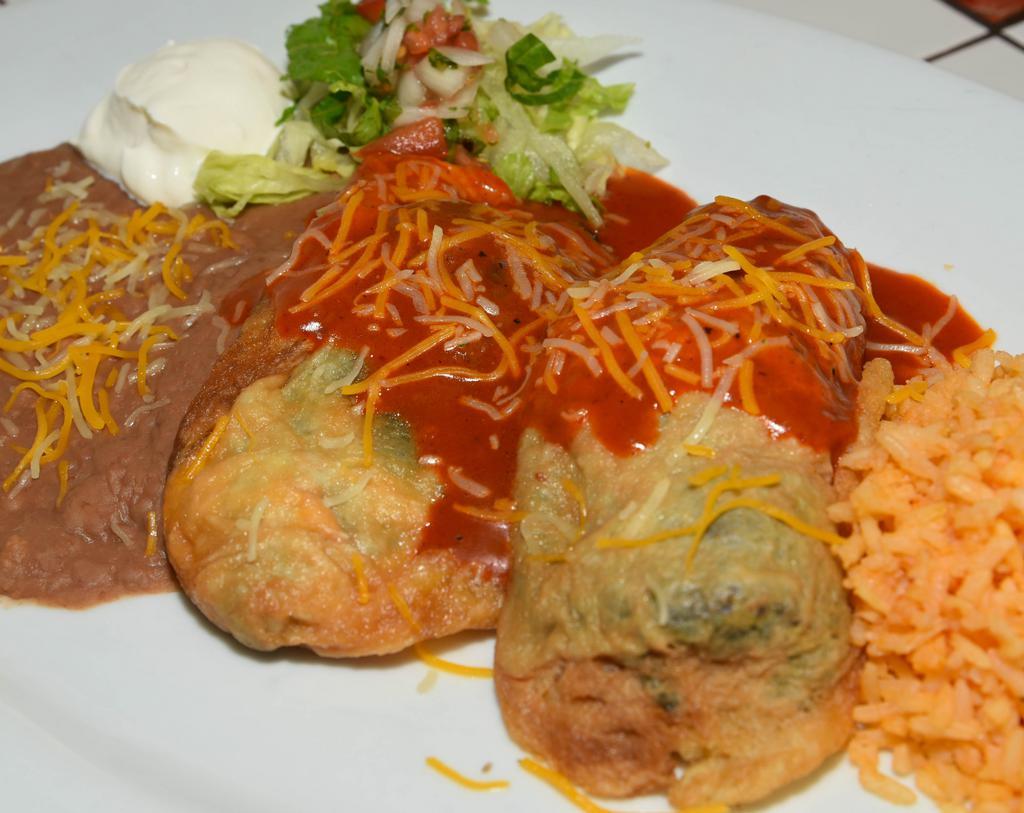 Chiles Rellenos · Topped with enchilada sauce 2 stuffed peppers filled with cheese. Warning: toothpick. NOTE: Plate comes with rice, beans, salad and sour cream