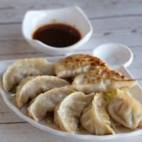 Pot Sticker · Pan-fried dumplings stuffed with cabbage, carrots, shiitake mushroom, and soy protein. Vegan.