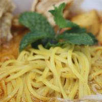 Curry Noodle · Yellow wheat noodles, bean sprouts, tofu, mint leaf, and fried bean curd. Vegan. Gluten-free.