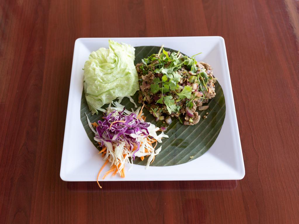 Yum Neau · Thinly sliced BBQ beef tossed with Thai herbs, lime juice. Thai sauce mixed with green salad.