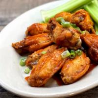 Brewpub Wings · One pound of chicken wings tossed in choice of sauce. Served with celery sticks and dipping ...