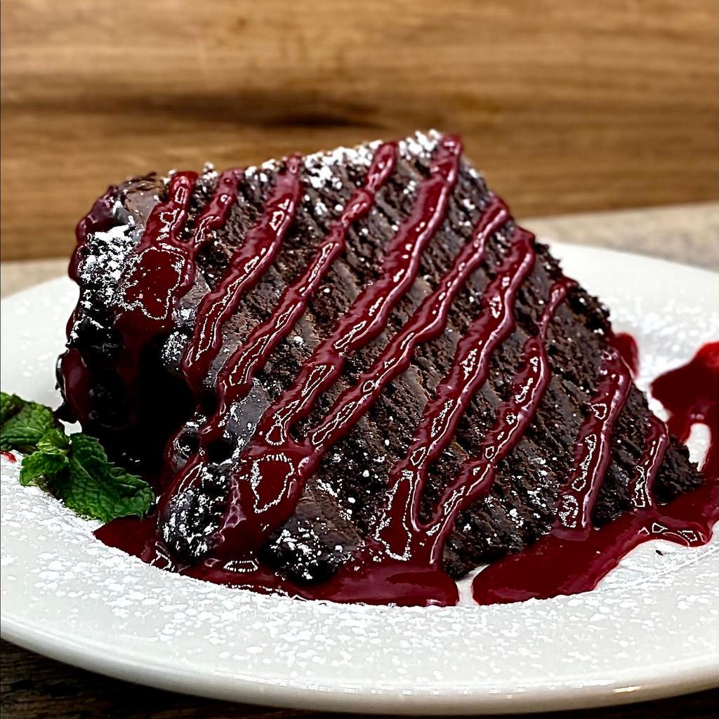 BA 12-Layer Chocolate Cake · This beast is great for sharing! Layer after layer of chocolate
ganache between dark moist chocolate cake. Finished with a
drizzle of delicious raspberry puree and a dusting of powdered
sugar.