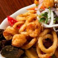Jalea de Mariscos · Seasoned fish and sea food stir fry cook served with fried yuca, creole onions and tartar sa...