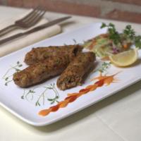 25. Lamb Seekh Kabab · Skewered ground lamb meat with spices and herbs. Served with rice and peas.