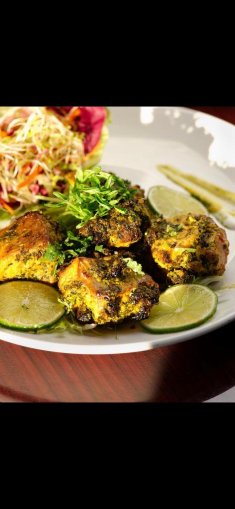 29. Methi Salmon · Marinated with fenugreek, olive oil, ginger and garlic. Served with rice and peas.