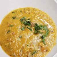 36. Peeli Dal · Yellow lentils cooked with onion and tomatoes, tempered with aromatic spices. Served with ri...