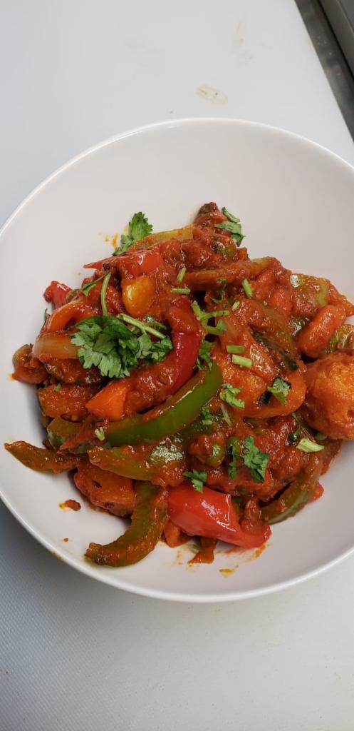 45. Jalfrezi Curry · Tomato curry with stir fried onion, bell peppers and ginger. Served with rice and peas.