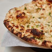 69. Garlic Naan · Light soft flat white bread topped with chopped garlic and cilantro.