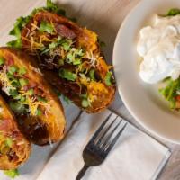 Potato Skins · Crispy potato skins loaded with melted cheese, crispy bacon and fresh chopped green onions. ...