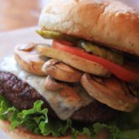 Sauteed Mushroom Swiss Burger · Cooked medium well and served with tomato, lettuce, pickles on a whole wheat bun with your c...