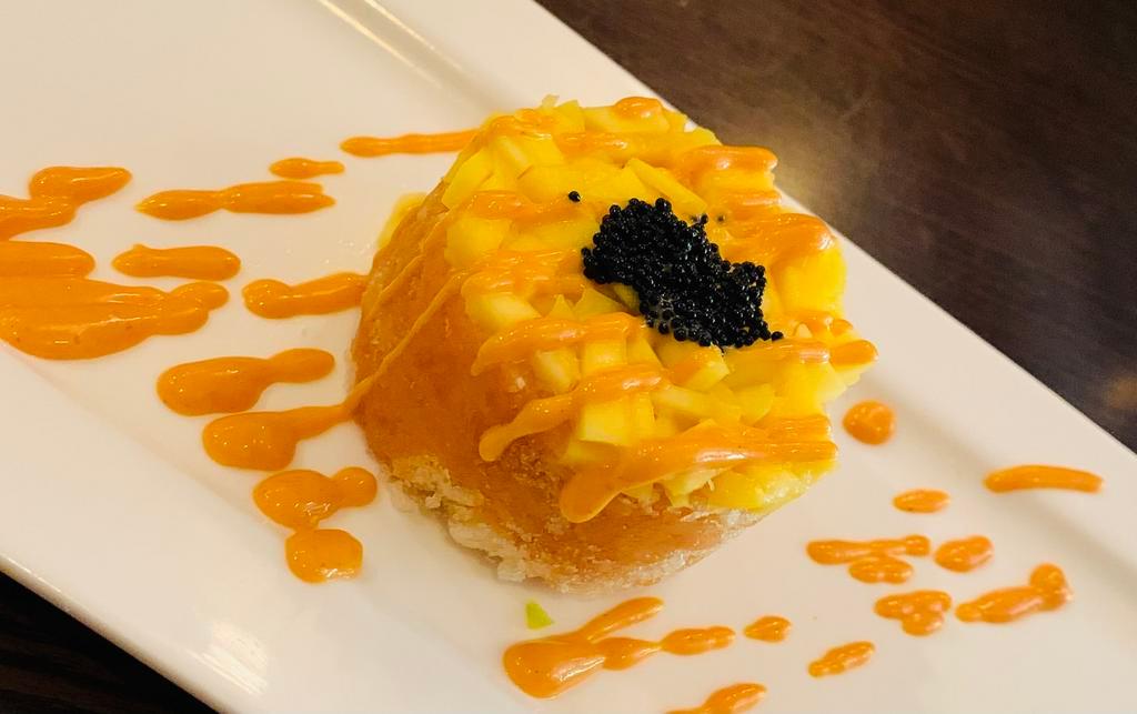 Spicy Salmon Tartare · Chop spicy salmon crunchy mixed dice mango and black tobiko on top.