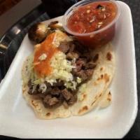 Grilled Steak Taco · Grilled steak topped with cabbage.
Carne asada con repollo.