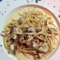 Fettuccini Alfredo · Fettucine pasta sautéed in our creamy alfredo sauce