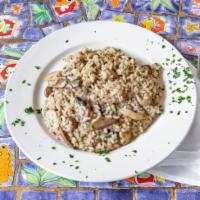 Mushroom Risotto · Italian arborio rice simmered with wild mushrooms for a creamy risotto