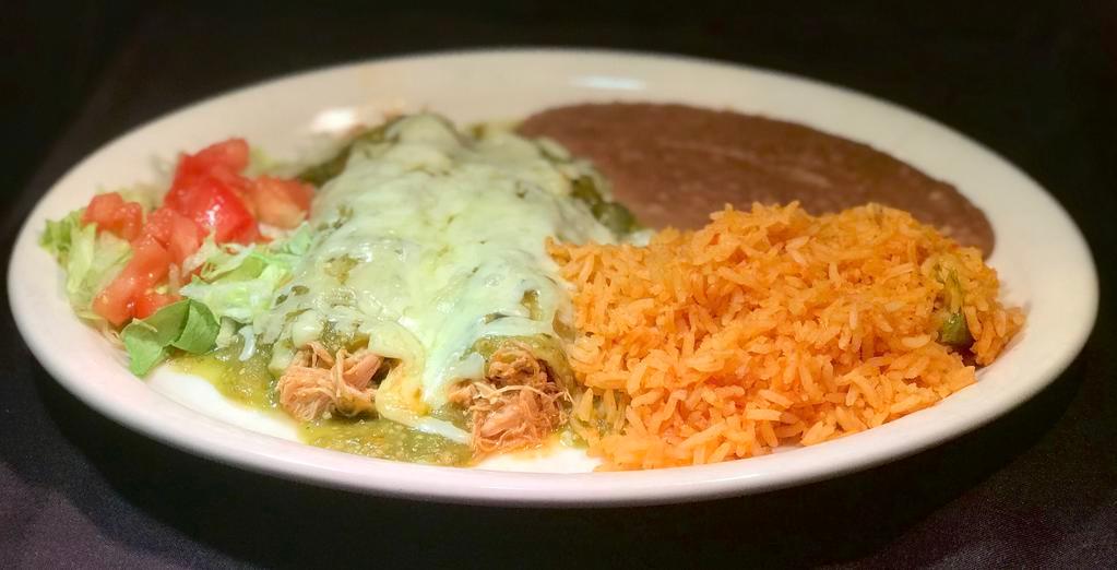 Enchiladas Verdes · 2 chicken enchiladas smothered in tangy green tomatillo sauce, Monterrey Jack cheese and topped with sour cream. Served with Spanish rice and beans.