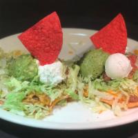 Tostada Compuesta · Choice of 2 beef, chicken or bean and cheese chalupas with lettuce, tomato, guacamole and so...