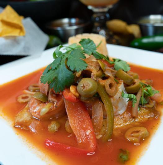 Tilapia Veracruz · Delicate fillet of tilapia sauteed with shrimp, tomato sauce, roasted poblano strips, and olives. Served with your choice of rice or mashed potatoes.
